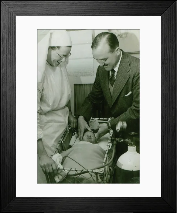 Framed Print : Dr Geoffrey Mutton and Matron Joan Gardner attend to a baby at St Monan's Hospital, c1950 Framed Print : Dr Geoffrey Mutton and Matron Joan Gardner attend to a baby at St Monan's Hospital, c1950