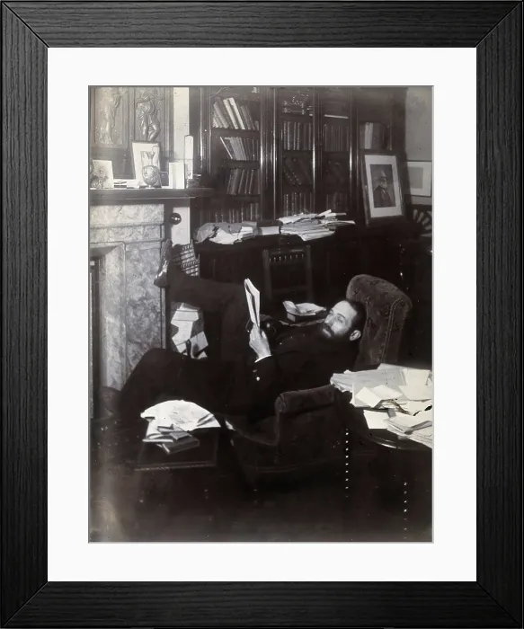 Framed Print : Arthur Schuster, lying on an armchair by a fireplace, with a photograph of Lord Kelvin... c1901. Creator: Unknown Framed Print : Arthur Schuster, lying on an armchair by a fireplace, with a photograph of Lord Kelvin... c1901. Creator: Unknown