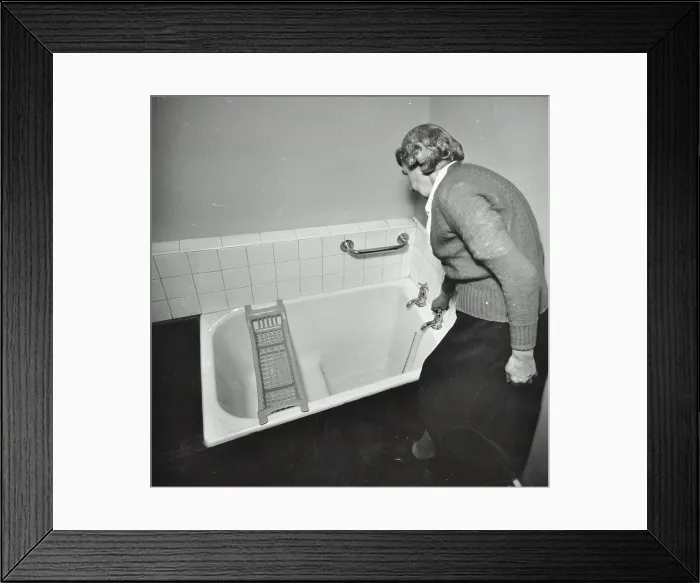 Framed Print : 16 Candy Street, Poplar, London: elderly woman in bathroom, 1962. Creator: Unknown