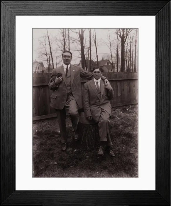 Framed Print : Untitled (two men holding small dog; one sitting on a stump, Fisher St. backyard), c1915. Creator: Wendell Hotter Framed Print : Untitled (two men holding small dog; one sitting on a stump, Fisher St. backyard), c1915. Creator: Wendell Hotter