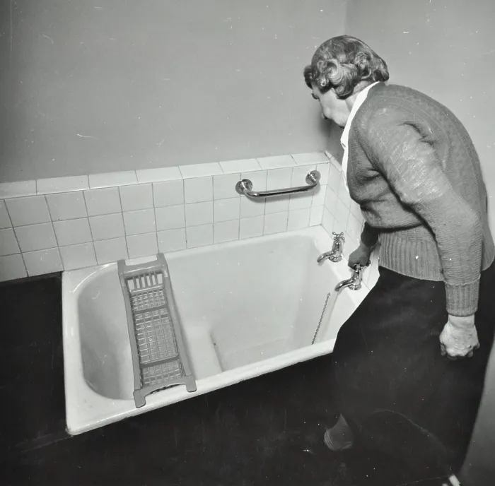 Framed Print : 16 Candy Street, Poplar, London: elderly woman in bathroom, 1962. Creator: Unknown