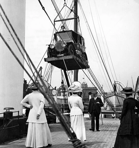 1910 Mercedes being craned onboard ship. Creator: Unknown