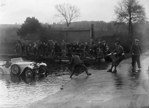 1935 Frazer-Nash TT replica being pulled out of a ford during a motoring trial, 1936