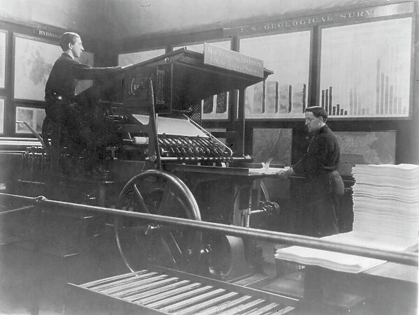 2 men operating map printing press at U.S. Geol. Survey, (1900?). Creator: Frances Benjamin Johnston