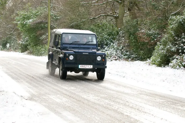 Framed Print : 2002 Land Rover Defender driving on snowy road, 2009 Framed Print : 2002 Land Rover Defender driving on snowy road, 2009