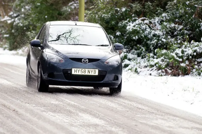 Framed Print : 2009 Mazda 2 driving on snowy road Framed Print : 2009 Mazda 2 driving on snowy road