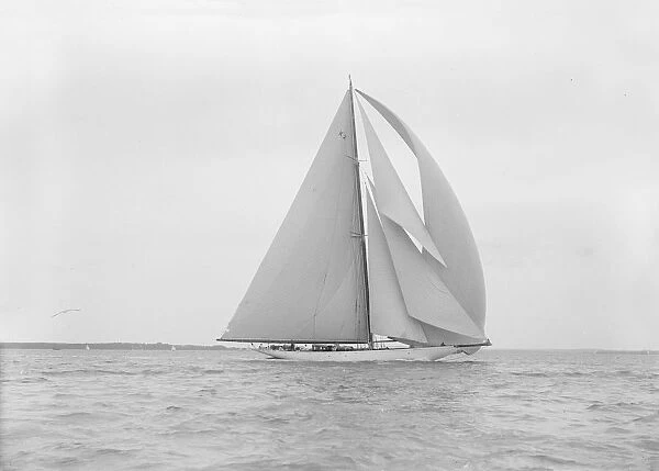The 23-metre cutter Astra sailing with spinnaker. Creator: Kirk & Sons of Cowes