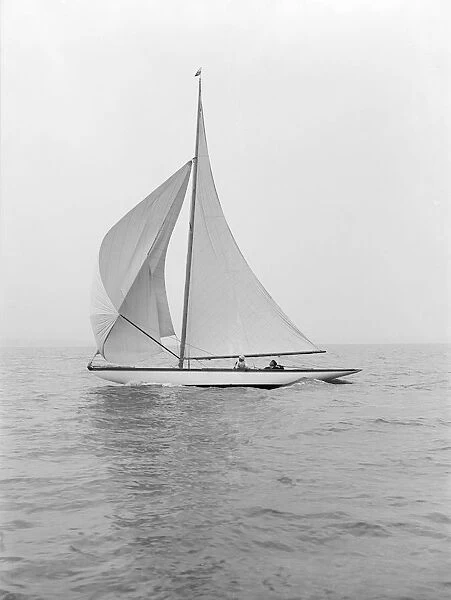 The 6 Metre class Marmi sailing under spinnaker, 1914. Creator: Kirk & Sons of Cowes