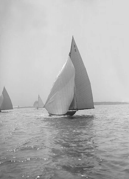 The 7 Metre yacht Pinaster (K8) sailing with spinnaker, 1914. Creator: Kirk & Sons of Cowes