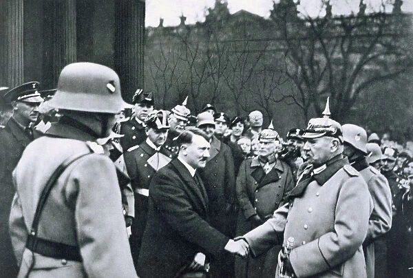 Adolf Hitler shaking hands with President von Hindenburg on the State Day of Honour, 1934