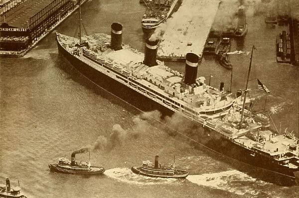 An Aerial Photograph of the Leviathan Being Towed By Small Tugs Into