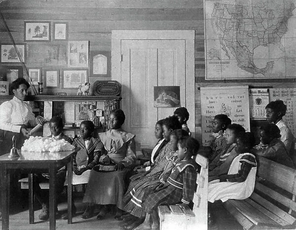 African American children and teacher in classroom studying... Annie Davis School...Alabama, c1902. Creator: Frances Benjamin Johnston
