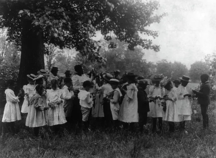 Framed Print : African American school children and teacher, studying leaves out of doors, (1899?). Creator: Frances Benjamin Johnston Framed Print : African American school children and teacher, studying leaves out of doors, (1899?). Creator: Frances Benjamin Johnston