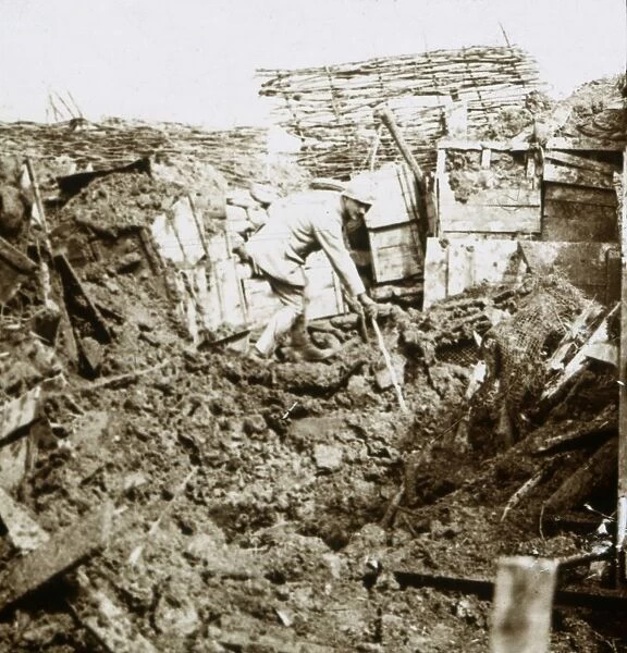 Aftermath of a shell, a soldier in the crater, c1914-c1918
