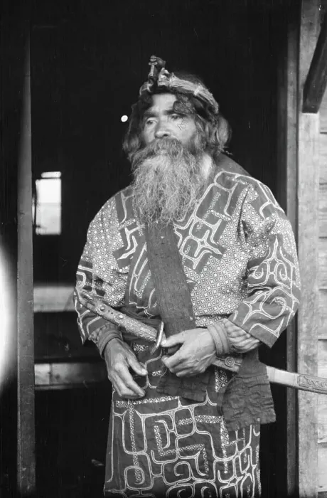 Framed Print : Ainu chief wearing a headdress and holding a sword standing in a doorway, 1908. Creator: Arnold Genthe Framed Print : Ainu chief wearing a headdress and holding a sword standing in a doorway, 1908. Creator: Arnold Genthe