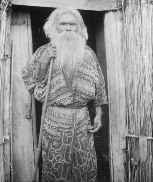 Framed Print : Ainu man holding a staff standing at the doorway of a hut, 1908. Creator: Arnold Genthe Framed Print : Ainu man holding a staff standing at the doorway of a hut, 1908. Creator: Arnold Genthe