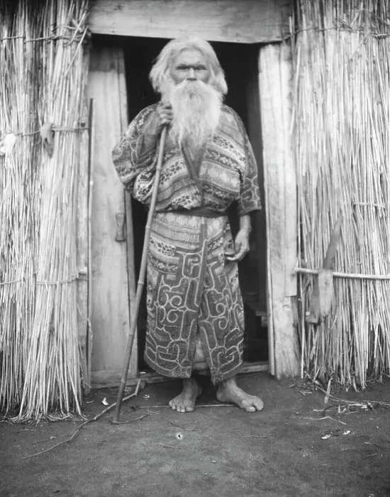 Framed Print : Ainu man holding a staff standing at the doorway of a hut, 1908. Creator: Arnold Genthe Framed Print : Ainu man holding a staff standing at the doorway of a hut, 1908. Creator: Arnold Genthe