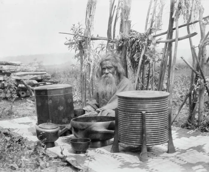 Framed Print : Ainu man seated outdoors on a mat covered with clay containers, 1908. Creator: Arnold Genthe Framed Print : Ainu man seated outdoors on a mat covered with clay containers, 1908. Creator: Arnold Genthe