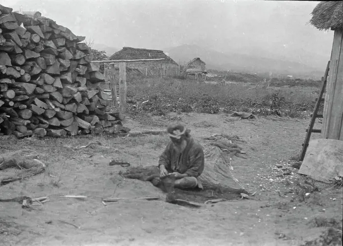 Framed Print : Ainu man seated outside working on nets, 1908. Creator: Arnold Genthe Framed Print : Ainu man seated outside working on nets, 1908. Creator: Arnold Genthe