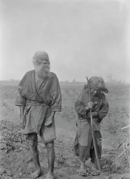 Framed Print : Ainu man and woman standing outside, 1908. Creator: Arnold Genthe Framed Print : Ainu man and woman standing outside, 1908. Creator: Arnold Genthe