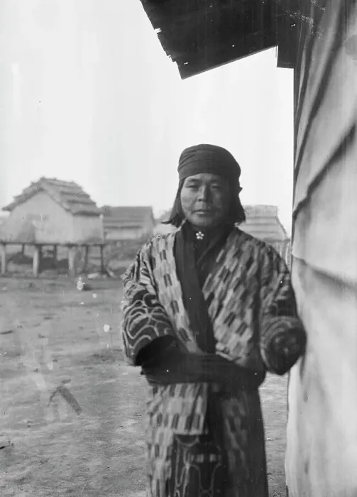 Framed Print : Ainu standing outside by the wall of a wooden hut, 1908. Creator: Arnold Genthe Framed Print : Ainu standing outside by the wall of a wooden hut, 1908. Creator: Arnold Genthe