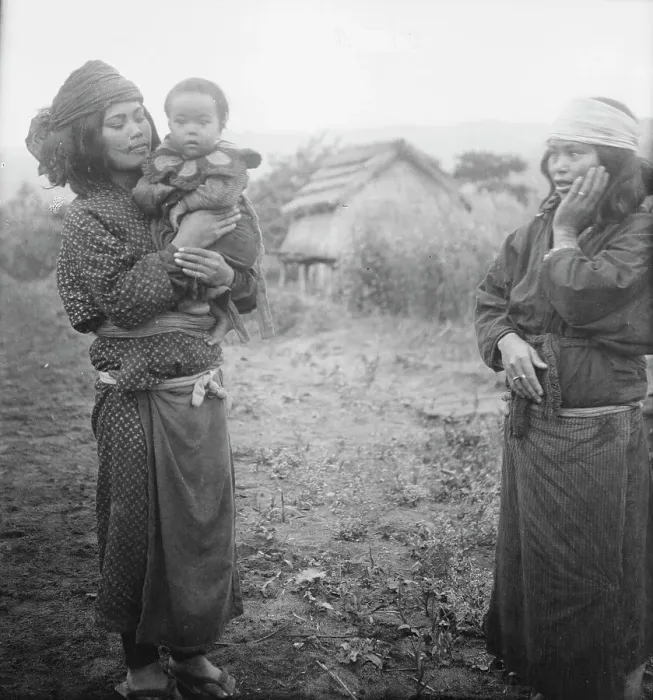 Framed Print : Two Ainu woman, one holding a child, standing outside, 1908. Creator: Arnold Genthe