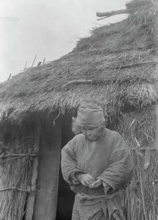 Framed Print : Ainu woman outside a hut, 1908. Creator: Arnold Genthe Framed Print : Ainu woman outside a hut, 1908. Creator: Arnold Genthe