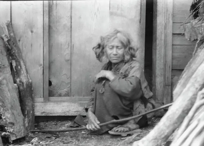 Framed Print : Ainu woman seated by the door of a wooden hut, 1908. Creator: Arnold Genthe Framed Print : Ainu woman seated by the door of a wooden hut, 1908. Creator: Arnold Genthe