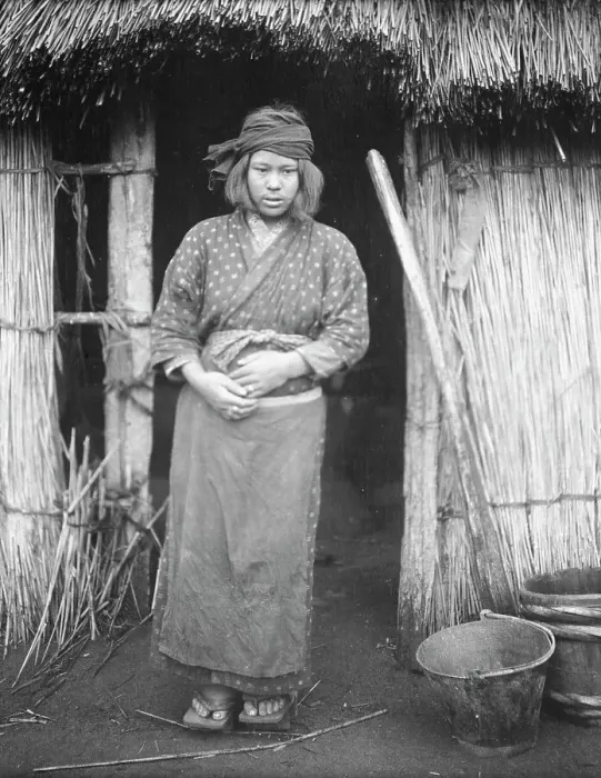 Framed Print : Ainu woman standing by the doorway of a hut, 1908. Creator: Arnold Genthe Framed Print : Ainu woman standing by the doorway of a hut, 1908. Creator: Arnold Genthe