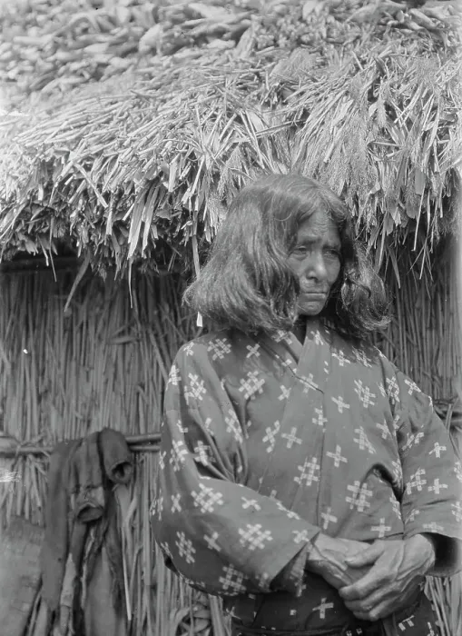 Framed Print : Ainu woman standing outside a hut, 1908. Creator: Arnold Genthe Framed Print : Ainu woman standing outside a hut, 1908. Creator: Arnold Genthe
