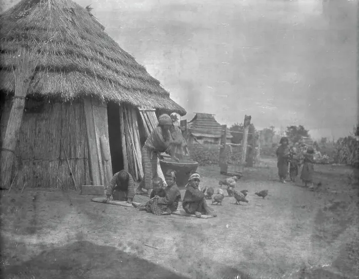 Framed Print : Ainu women and children outside a hut, 1908. Creator: Arnold Genthe Framed Print : Ainu women and children outside a hut, 1908. Creator: Arnold Genthe