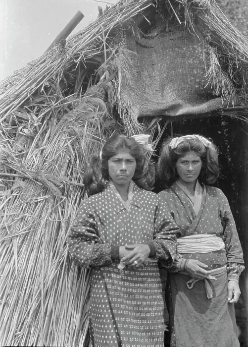 Framed Print : Two Ainu women standing at the entrance of a hut, 1908. Creator: Arnold Genthe Framed Print : Two Ainu women standing at the entrance of a hut, 1908. Creator: Arnold Genthe