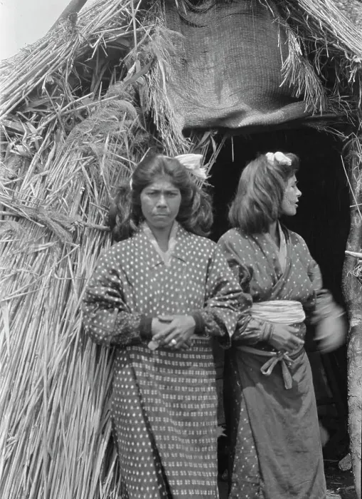 Framed Print : Two Ainu women standing outside the entrance of a hut, 1908. Creator: Arnold Genthe Framed Print : Two Ainu women standing outside the entrance of a hut, 1908. Creator: Arnold Genthe
