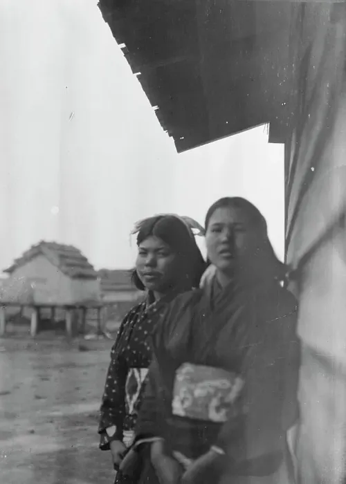 Framed Print : Two Ainu women standing outside by the wall of a wooden hut, 1908. Creator: Arnold Genthe Framed Print : Two Ainu women standing outside by the wall of a wooden hut, 1908. Creator: Arnold Genthe