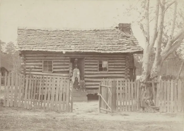 Framed Print : Albumen print of a woman and two children in front of a log house in Georgia, 1880s Framed Print : Albumen print of a woman and two children in front of a log house in Georgia, 1880s