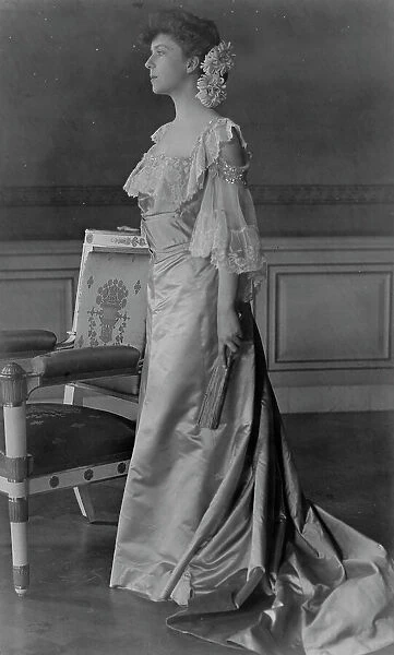 Alice Roosevelt Longworth, full-length portrait, standing next to chair, facing left, 1903. Creator: Frances Benjamin Johnston