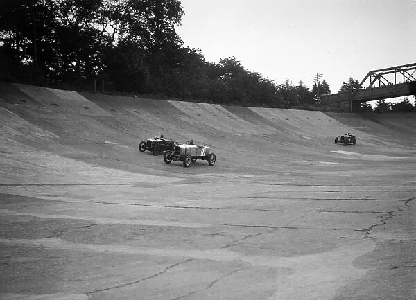 Alvis 17 and Austin 747 cc racing on the banking at Brooklands. Artist: Bill Brunell