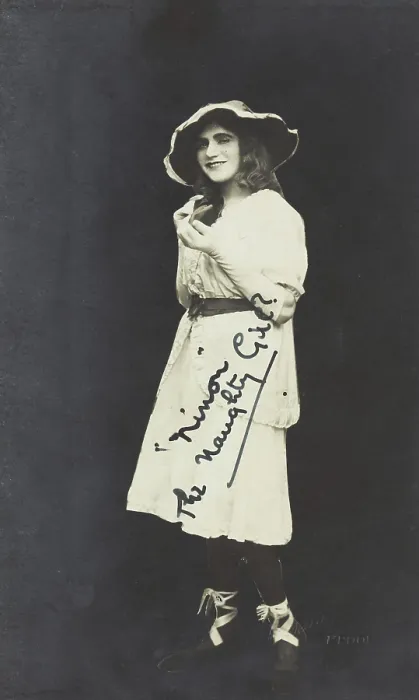 Framed Print : An amateur actor in drag, posing as Ninon, wearing a white dress and hat, [between 1920 and 1929