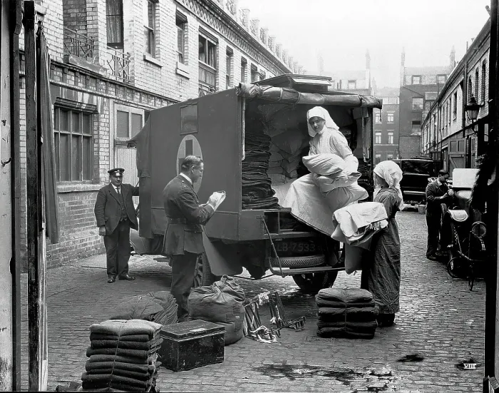 Framed Print : Ambulance Column depot, 9 Gower Street, London: loading up the blanket bus in Gower Mews, 1918. Creator: Unknown Framed Print : Ambulance Column depot, 9 Gower Street, London: loading up the blanket bus in Gower Mews, 1918. Creator: Unknown