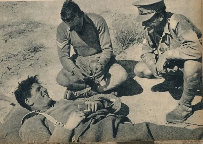 Framed Print : Ambulance men with a wounded anti-tank gunner, c1942 (1944) Framed Print : Ambulance men with a wounded anti-tank gunner, c1942 (1944)