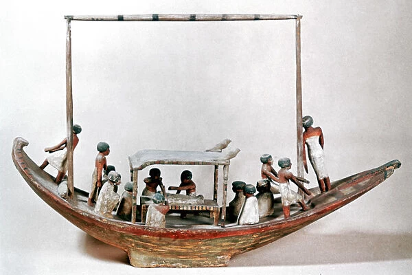 Ancient Egyptian model of a boat carrying a mummy to its tomb