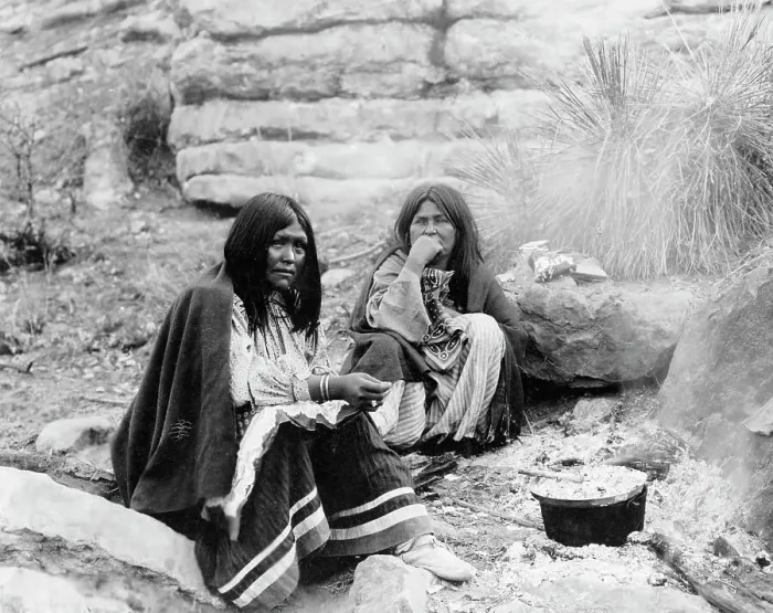 Framed Print : Two Apache Indian women at campfire, cooking pot in front of one, c1903. Creator: Edward Sheriff Curtis Framed Print : Two Apache Indian women at campfire, cooking pot in front of one, c1903. Creator: Edward Sheriff Curtis