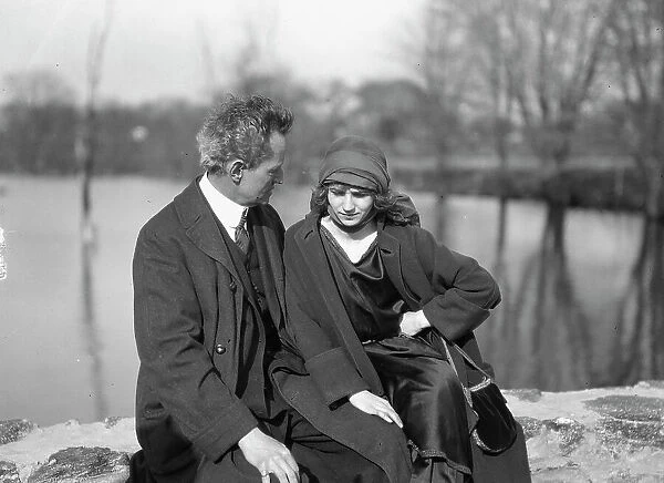 Arnold Genthe seated outdoors with a woman friend, between 1896 and 1942. Creator: Arnold Genthe