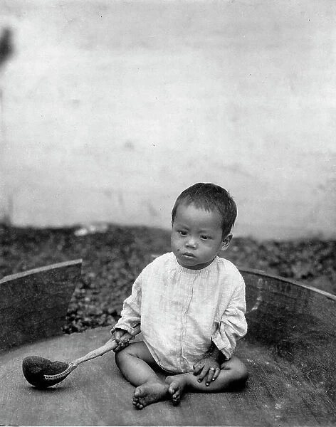 Asian(?) baby seated holding spoon or ladle, World's Columbian Exposition, Chicago, Ill. 1891 or 92 Creator: Frances Benjamin Johnston