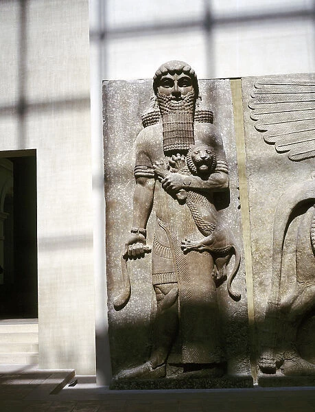 Assyrian sculpture of a man holding a lion, Khorsabad, c8th century BC
