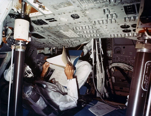 An astronaut inside a NASA Command Module, 1970s. Artist: NASA