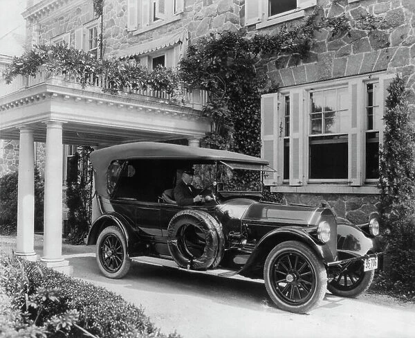 Automobile owned by Mrs. Charles W. Richardson in driveway with driver at the...Washington DC, c1919 Creator: Frances Benjamin Johnston