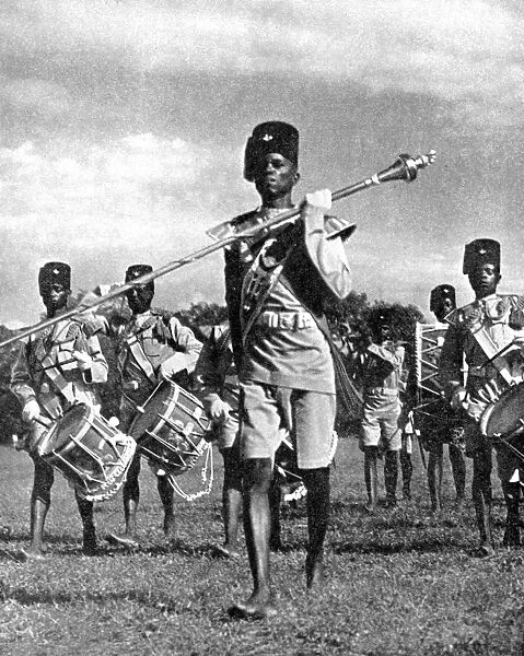 Bandsmen of the Northern Rhodesia Regiment beat a military tattoo, Zimbabwe, Africa, 1936. Artist: LNA Images