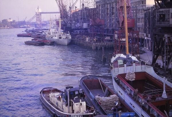 Barges in the Pool of London. River Thames and Tower Bridge, London, 1962. Artist: CM Dixon