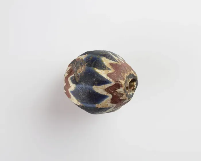 Framed Print : Bead, egg-shaped, with chamfered sides. Two sides chipped away, 13th-14th centuries Framed Print : Bead, egg-shaped, with chamfered sides. Two sides chipped away, 13th-14th centuries